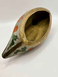 Decorative brass container with painted design on a white background