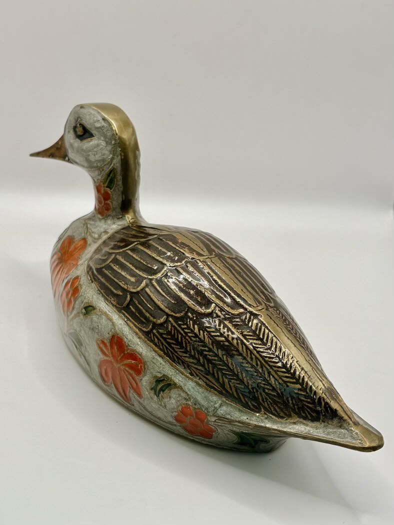 Decorative ceramic duck with floral patterns on a white background