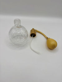 Clear glass bottle with a gold cap on a white background