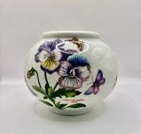 White ceramic jar with floral design on a white background