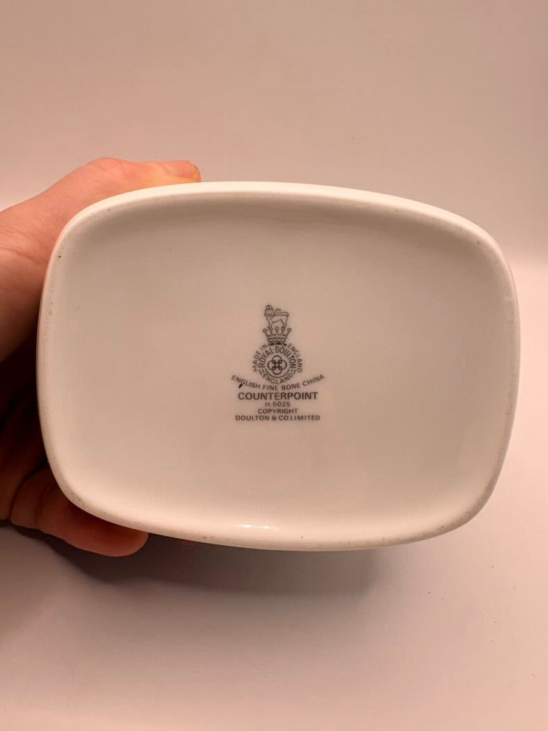 White ceramic dish held by a hand with 'Counterpoint' branding on a light background