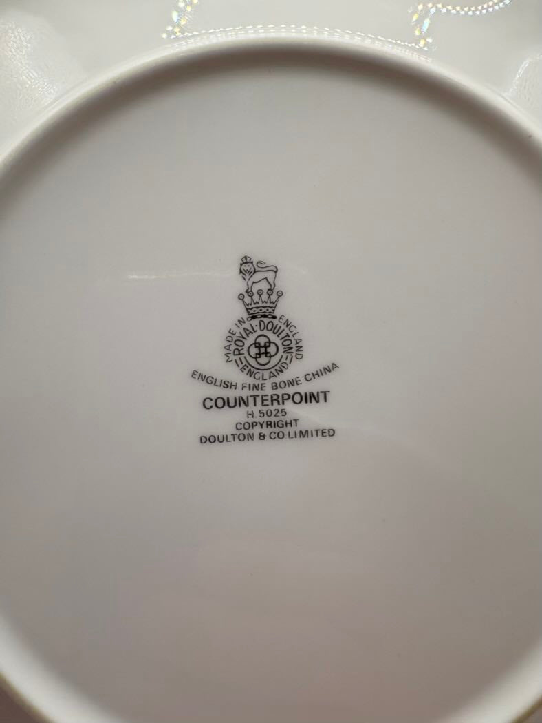 White bottom of a cup with black text and logo on a white background