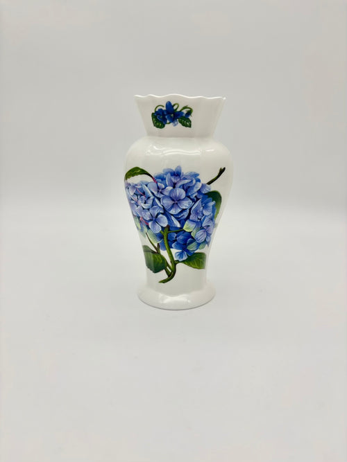 White ceramic vase with blue floral design on a white background