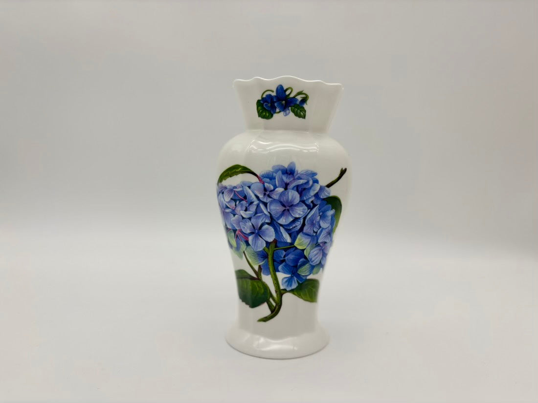 White ceramic vase with blue floral design on a gray background