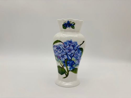 White ceramic vase with blue floral design on a gray background