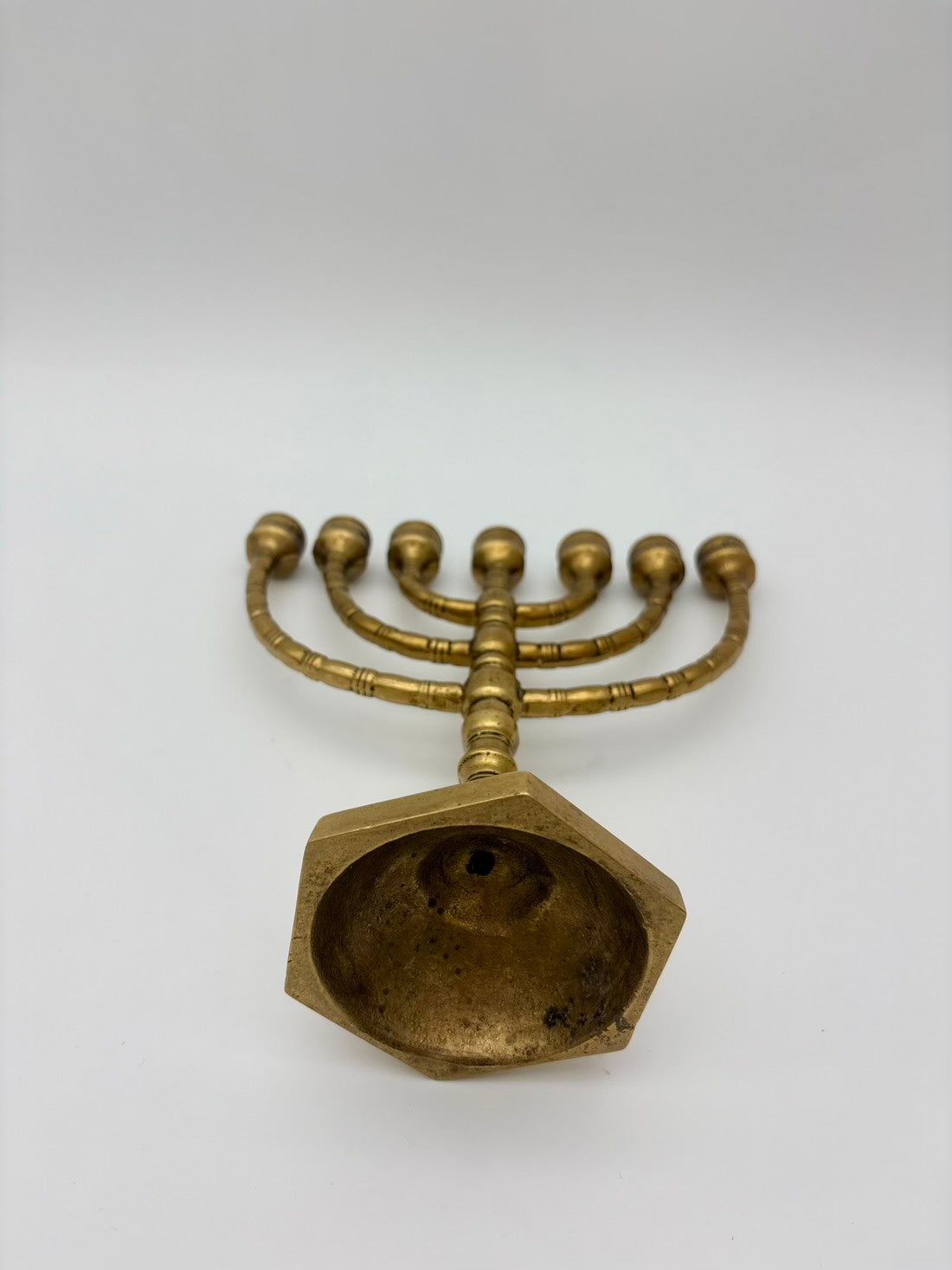 Brass menorah on a white background