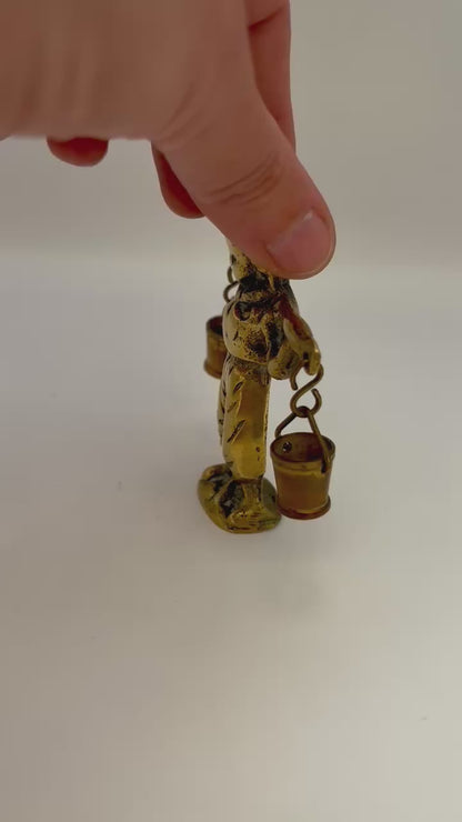 Video of Vintage brass figurine of a boy carrying water buckets, rustic art deco home decor