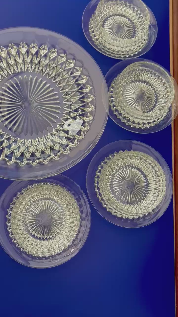 video of Vintage clear glass dessert set with diamond cut pattern, including bowls, saucers, and a serving plate