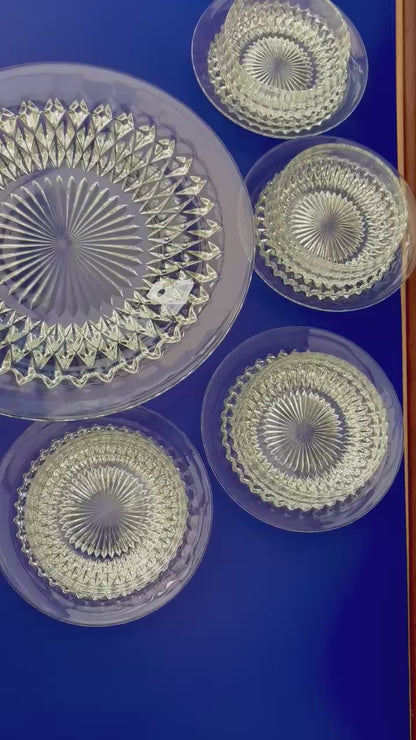 video of Vintage clear glass dessert set with diamond cut pattern, including bowls, saucers, and a serving plate
