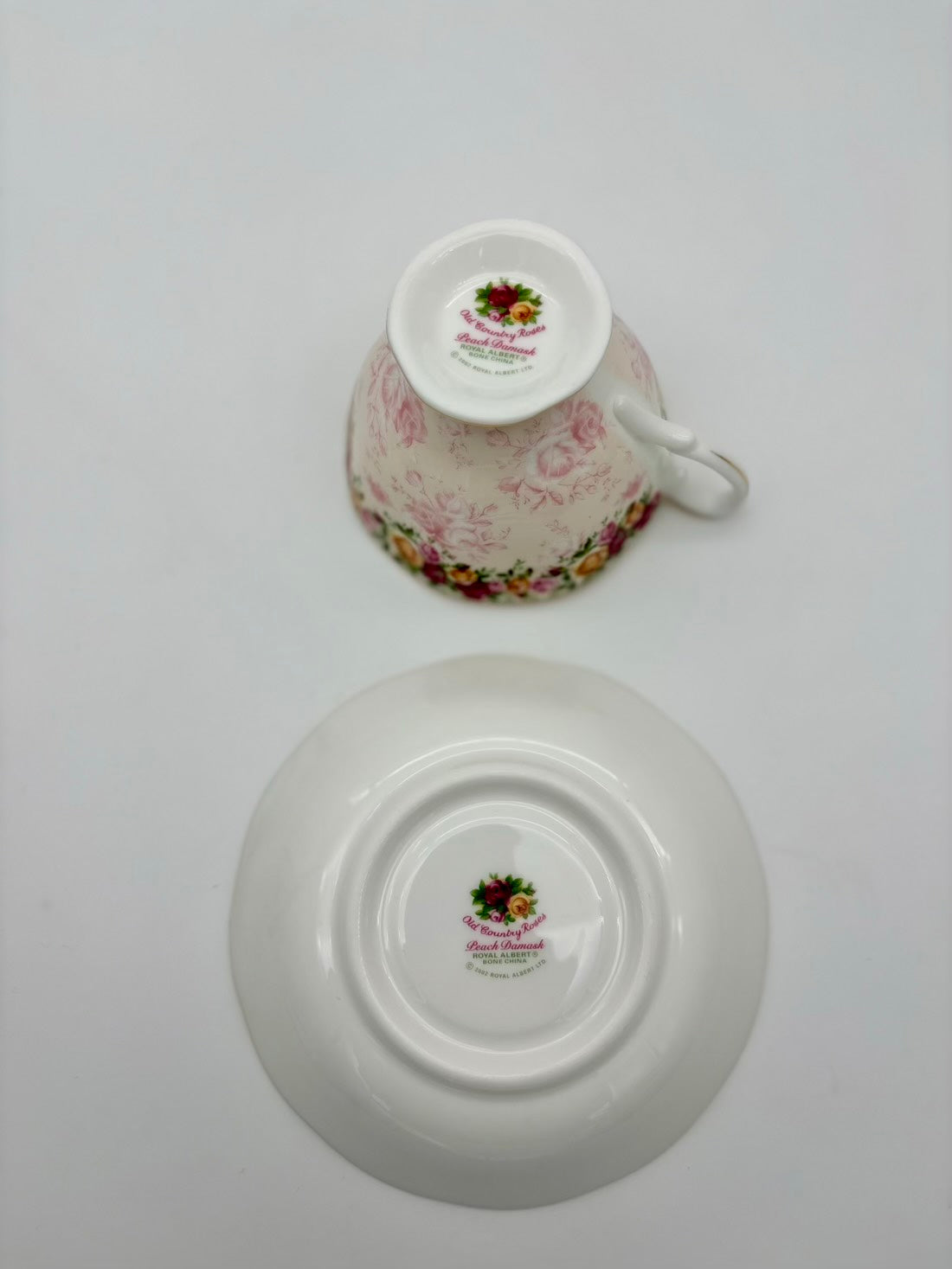 Floral-patterned teacup and saucer on a white background