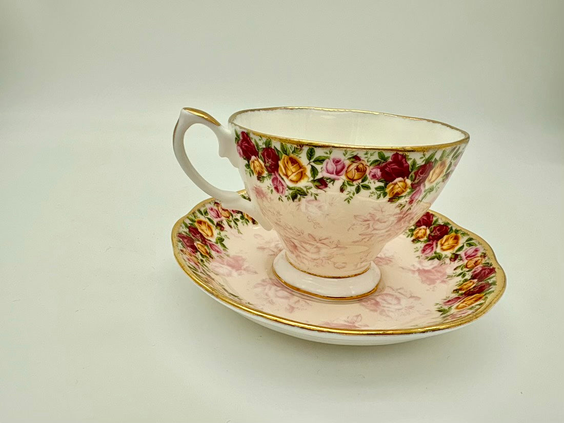 Teacup and saucer with floral design on a plain background