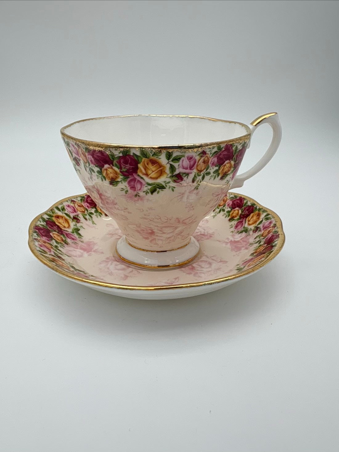 Floral teacup and saucer set on a white background