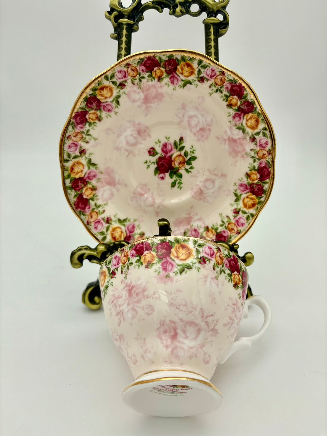 Vintage-style teacup and saucer with floral design on a white background