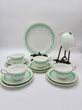 Tea set with green and white pattern on a white background