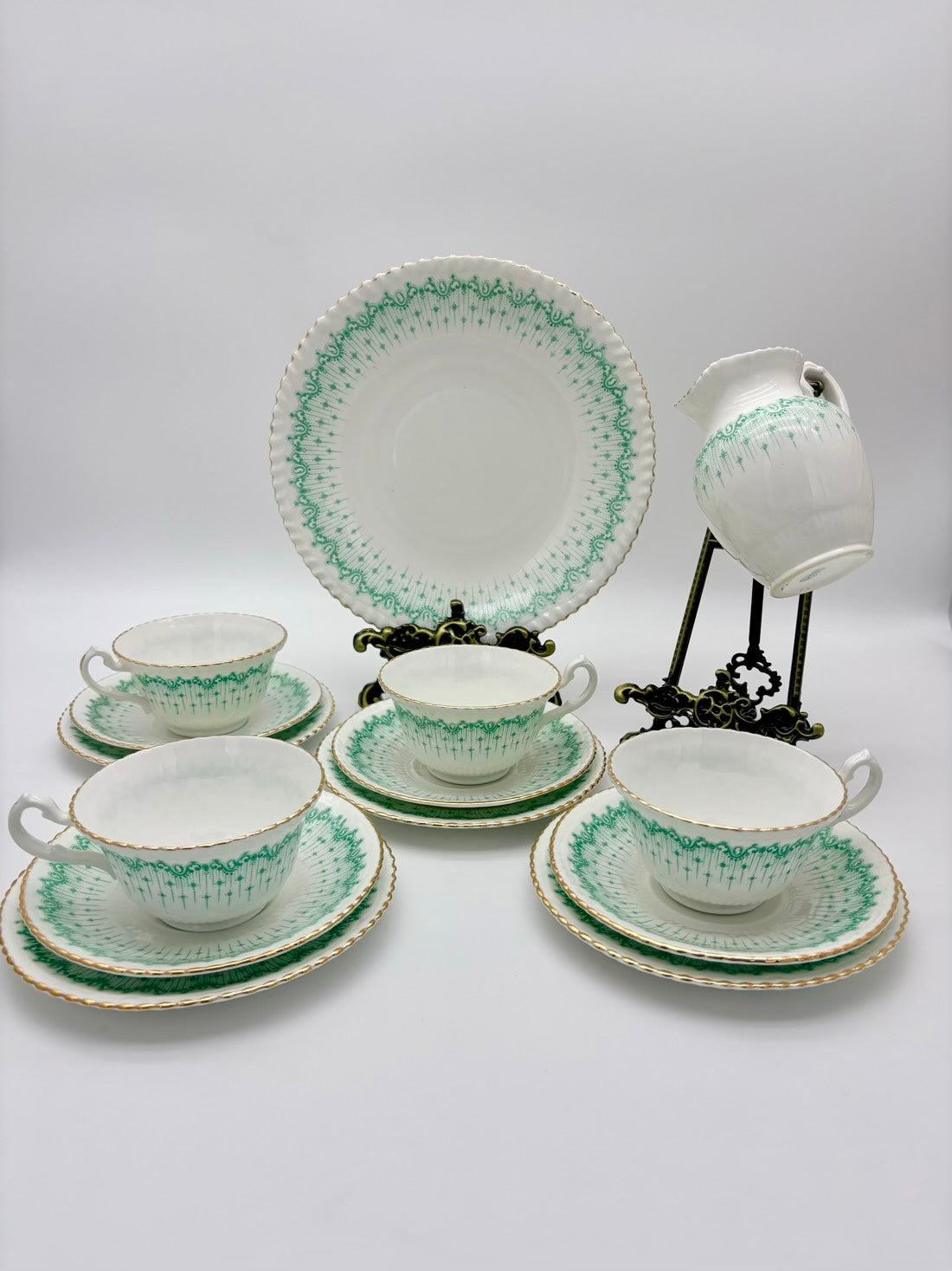 Tea set with green and white pattern on a white background