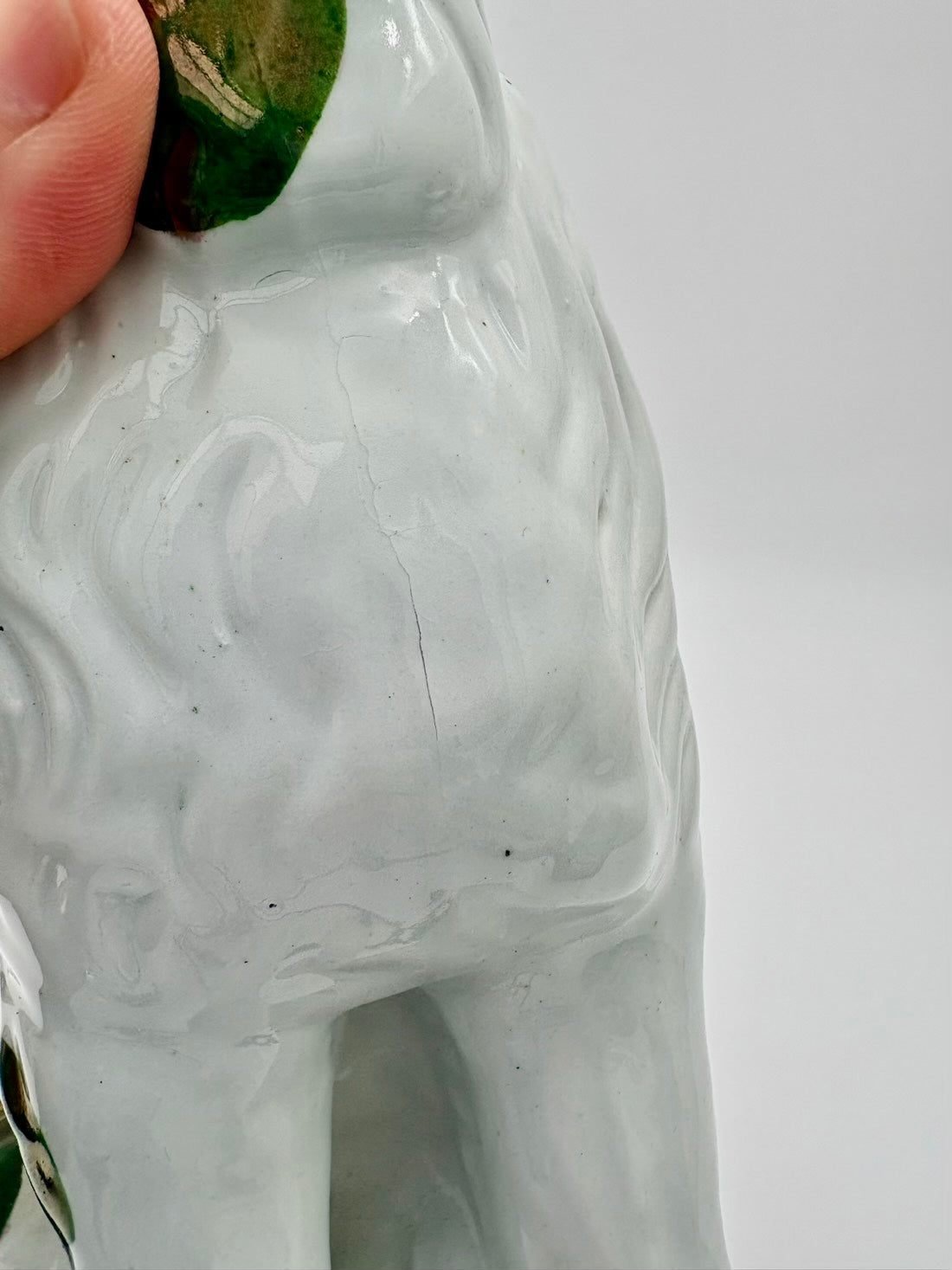 Close-up of a ceramic horse figure with a plain background