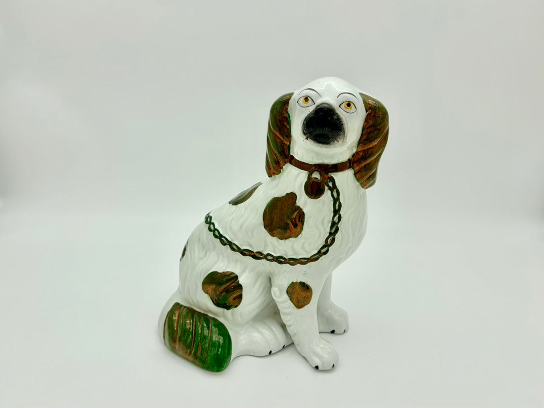Dog-shaped ceramic jar with a chain on a white background