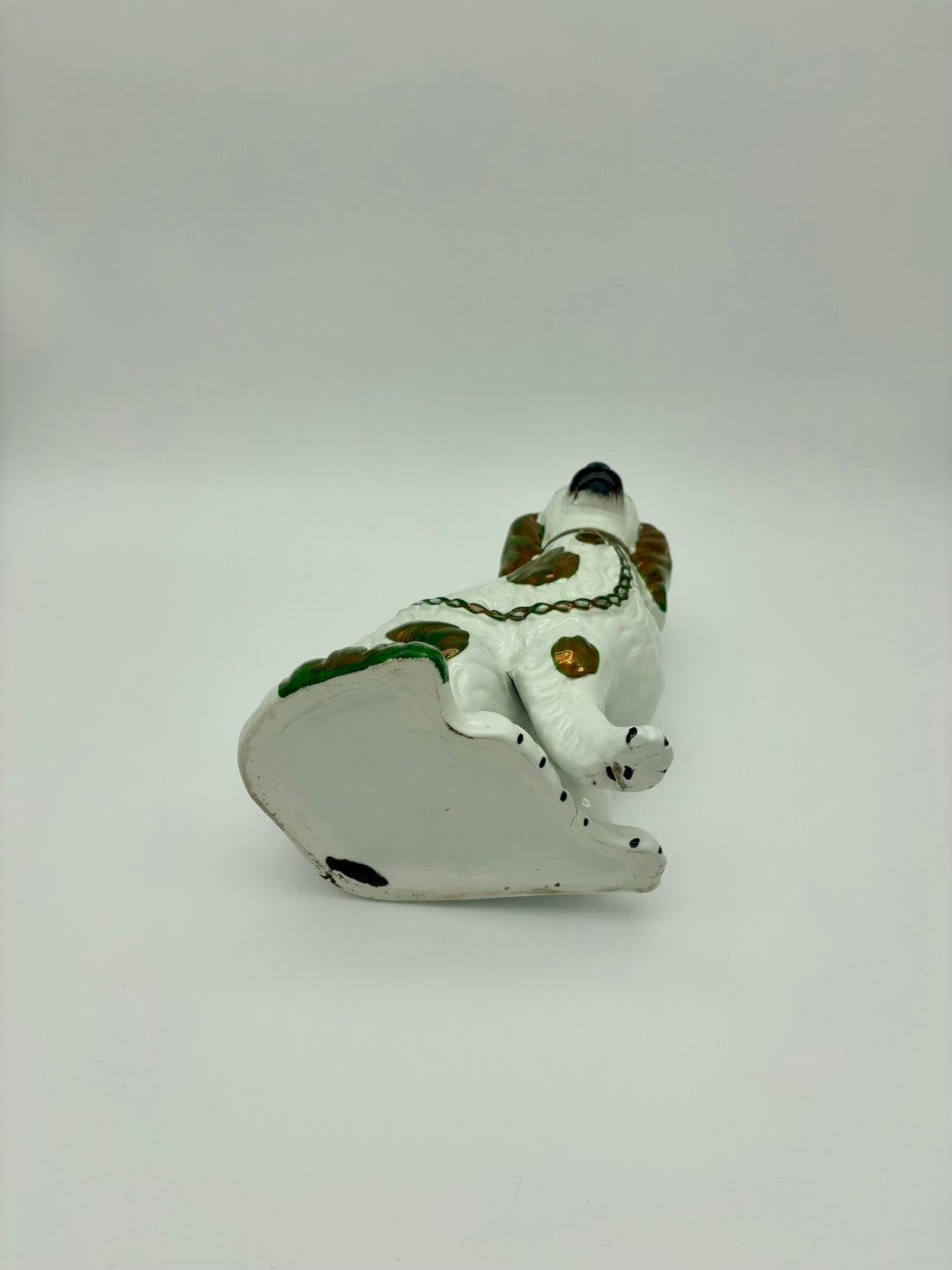 Small ceramic lizard figurine on a white background